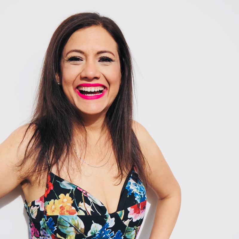 Portrait of Erlinda Vo smiling against a light background